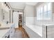 A bathroom features a closet, a window above a tub, and a bright vanity with a sink at 6480 Beaver Creek Rd, New Hill, NC 27562