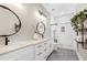 Modern bathroom featuring a double vanity, round mirrors, and a separate glass-enclosed shower at 6480 Beaver Creek Rd, New Hill, NC 27562