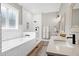 An elegant bathroom features a white tiled shower, a soaking tub, and and sinks at 6480 Beaver Creek Rd, New Hill, NC 27562