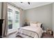 Comfortable bedroom with a large window offering views of the outdoors and a cozy fireplace at 6480 Beaver Creek Rd, New Hill, NC 27562