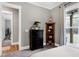 Bright bedroom featuring neutral walls, a window with natural light, and stylish décor at 6480 Beaver Creek Rd, New Hill, NC 27562