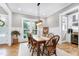 Elegant dining room with hardwood floors, wainscoting, and a stylish chandelier at 6480 Beaver Creek Rd, New Hill, NC 27562