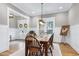 Well-lit dining area with hardwood floors, wainscoting, and modern lighting fixtures at 6480 Beaver Creek Rd, New Hill, NC 27562