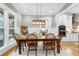 Elegant dining area with a wooden table, chandelier, and views of the kitchen at 6480 Beaver Creek Rd, New Hill, NC 27562