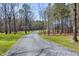 Long driveway leading to a home surrounded by a beautiful forest at 6480 Beaver Creek Rd, New Hill, NC 27562