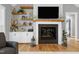 Living room fireplace with hearth, floating shelves, and cozy decor at 6480 Beaver Creek Rd, New Hill, NC 27562