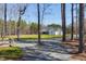 Expansive front yard with a long driveway leading to a stunning farmhouse at 6480 Beaver Creek Rd, New Hill, NC 27562