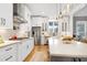 A view of a kitchen with stainless steel appliances, and bright white cabinets at 6480 Beaver Creek Rd, New Hill, NC 27562