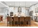 Bright kitchen with island seating, stainless appliances, white cabinets and pendant lighting at 6480 Beaver Creek Rd, New Hill, NC 27562