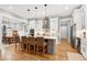 Open kitchen featuring a large island with seating, stainless steel appliances, and white cabinets at 6480 Beaver Creek Rd, New Hill, NC 27562