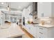 Open kitchen featuring white cabinets, granite countertops, stainless appliances, and a large center island at 6480 Beaver Creek Rd, New Hill, NC 27562