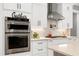 Close-up of a kitchen with stainless steel appliances and bright white cabinets at 6480 Beaver Creek Rd, New Hill, NC 27562