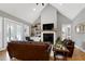 Cozy living room with vaulted ceilings, fireplace, and plenty of natural light at 6480 Beaver Creek Rd, New Hill, NC 27562