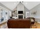 Bright living area featuring a fireplace, built-in shelving, and hardwood floors at 6480 Beaver Creek Rd, New Hill, NC 27562