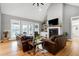 Cozy living room with a fireplace, vaulted ceiling, and comfortable leather seating at 6480 Beaver Creek Rd, New Hill, NC 27562