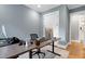 Home office with dual workstations, modern desk, chair, and convenient access to an adjacent bathroom at 6480 Beaver Creek Rd, New Hill, NC 27562