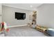 Spacious playroom with soft carpet, a large screen TV, and built in shelving for easy storage at 6480 Beaver Creek Rd, New Hill, NC 27562