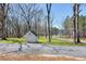 View of backyard shed with clean white walls and dark gray roof at 6480 Beaver Creek Rd, New Hill, NC 27562
