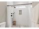 Sleek tiled shower featuring black fixtures, a shower nook, and a wooden stool at 6480 Beaver Creek Rd, New Hill, NC 27562