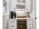 Chic wet bar with custom cabinets, wine storage, and beverage cooler at 6480 Beaver Creek Rd, New Hill, NC 27562
