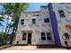 Unfinished exterior of a new construction home, wrapped in Tyvek HomeWrap, with windows installed and the framing exposed at 6960 Doddridge Ln # 15, Cary, NC 27519
