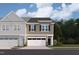 Charming two-story townhome features an attached garage and beautifully landscaped front yard at 6960 Doddridge Ln # 15, Cary, NC 27519