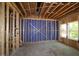 Unfinished basement features exposed framing, a concrete floor, and one window at 6962 Doddridge Ln # 14, Cary, NC 27519