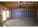 Unfinished basement featuring bare framing, a door to the outside, and overhead ductwork at 6962 Doddridge Ln # 14, Cary, NC 27519