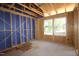 Bedroom under construction featuring exposed framing, unfinished walls, and two windows with a view at 6962 Doddridge Ln # 14, Cary, NC 27519