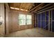 Bedroom under construction with exposed framing, two large windows, and views of the surrounding trees at 6962 Doddridge Ln # 14, Cary, NC 27519