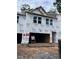Unfinished townhome exterior featuring the front entrance and a two-car garage under construction at 6962 Doddridge Ln # 14, Cary, NC 27519