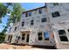 Exterior of new home showing tyvek wrapping, multiple windows, and a covered front entry at 6962 Doddridge Ln # 14, Cary, NC 27519