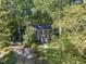 Aerial shot showcasing the brick home surrounded by lush greenery, with a well-kept lawn and spacious driveway at 721 Blenheim Dr, Raleigh, NC 27612