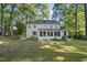 Expansive back exterior view of home with sunroom and basketball hoop at 721 Blenheim Dr, Raleigh, NC 27612