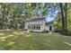 Wide angle of back exterior showing screened sunroom and partial yard at 721 Blenheim Dr, Raleigh, NC 27612
