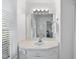 Bright bathroom featuring a white vanity with a sink, a large mirror, and natural light from the window at 721 Blenheim Dr, Raleigh, NC 27612
