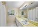 Well-lit bathroom with a double vanity, ample counter space, and a large mirror reflecting a clean design at 721 Blenheim Dr, Raleigh, NC 27612