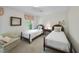 Cozy bedroom with two twin beds, classic wood frames, soft lighting and a peaceful view from the window at 721 Blenheim Dr, Raleigh, NC 27612