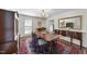 Classic dining room with wooden table and chairs on a decorative rug, complemented by elegant buffet and chandelier at 721 Blenheim Dr, Raleigh, NC 27612