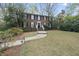 Charming brick home featuring a manicured lawn and inviting front entrance with classic black shutters and white trim at 721 Blenheim Dr, Raleigh, NC 27612