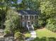 Charming brick home featuring a manicured lawn and inviting front entrance with classic black shutters and white trim at 721 Blenheim Dr, Raleigh, NC 27612