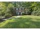 Beautiful red brick front elevation with black shutters and a luscious lawn at 721 Blenheim Dr, Raleigh, NC 27612
