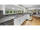 Granite countertop, stainless steel sink, white cabinets and open to the living room at 721 Blenheim Dr, Raleigh, NC 27612