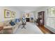 Cozy living room featuring hardwood floors, plantation shutters, and a neutral color palette with tastefully chosen furniture at 721 Blenheim Dr, Raleigh, NC 27612