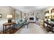 Comfortable living room with fireplace, light blue sofa, side tables and hardwood floors at 721 Blenheim Dr, Raleigh, NC 27612