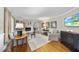 Bright living room showcasing fireplace, hardwood floors and a television for entertaining at 721 Blenheim Dr, Raleigh, NC 27612