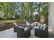 Outdoor patio with comfortable seating, surrounded by trees, creating a relaxing space for entertaining or unwinding at 721 Blenheim Dr, Raleigh, NC 27612