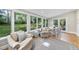 Sunroom featuring a cozy sitting area and dining table, perfect for enjoying views of the outdoors at 721 Blenheim Dr, Raleigh, NC 27612