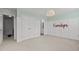 Bedroom with paneled walls and view to the ensuite bathroom at 7628 Winners Edge St, Raleigh, NC 27617