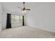 Bright bedroom with a ceiling fan and large windows at 7628 Winners Edge St, Raleigh, NC 27617